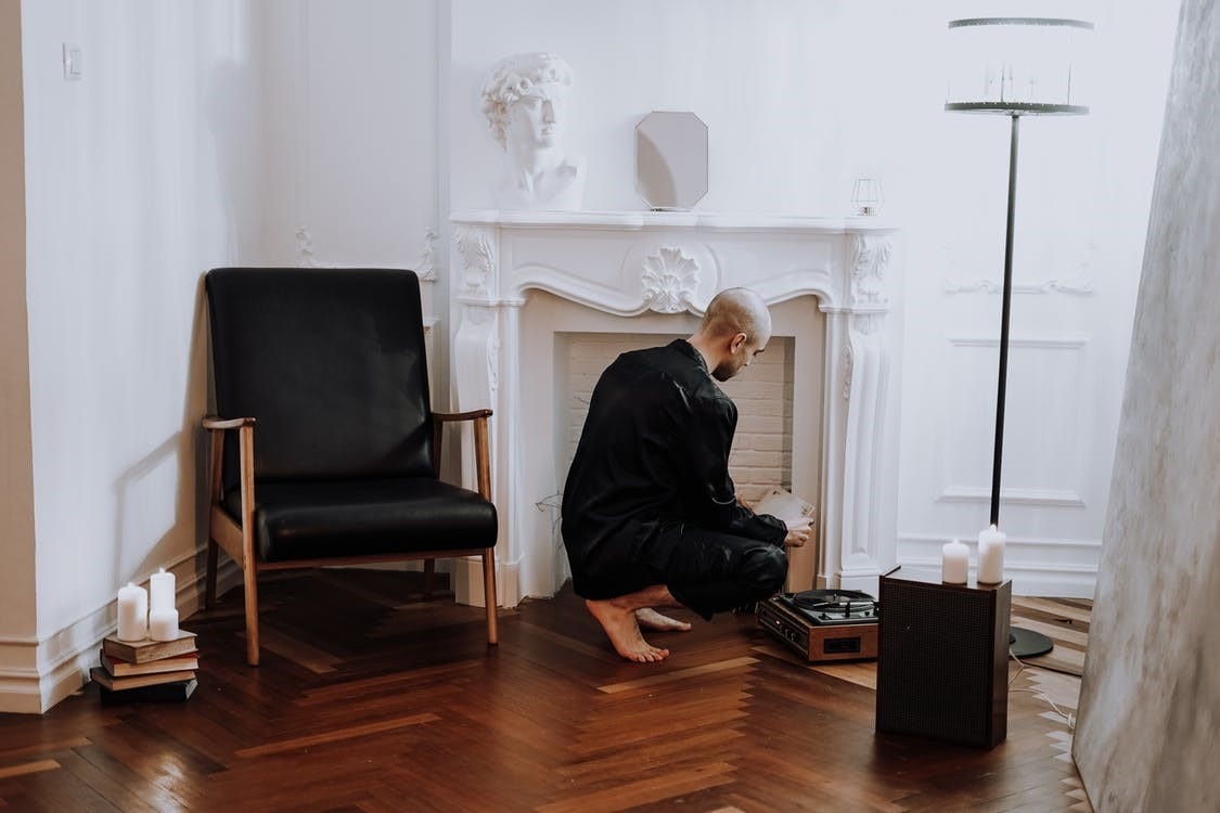 a man in black pant suit is working on vinyl flooring 